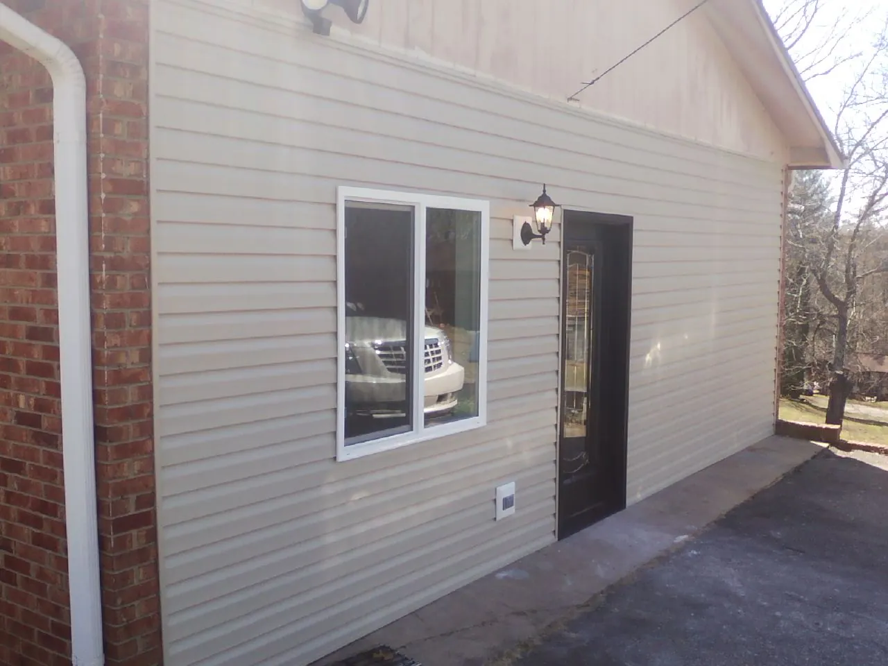 New vinyl siding and entry door on a room addition in Powell
